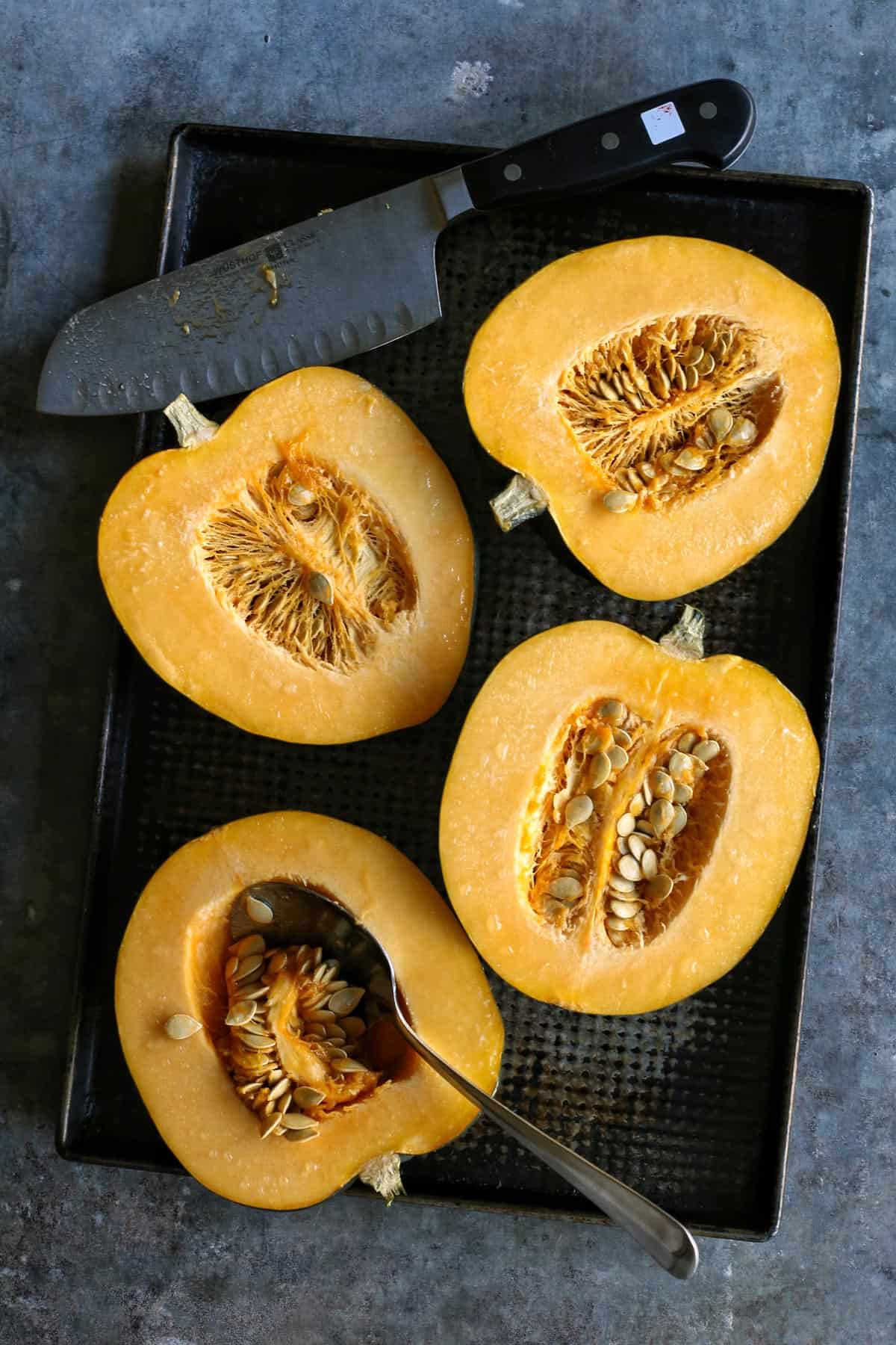 acorn squash cut in half, to reveal inner seeds