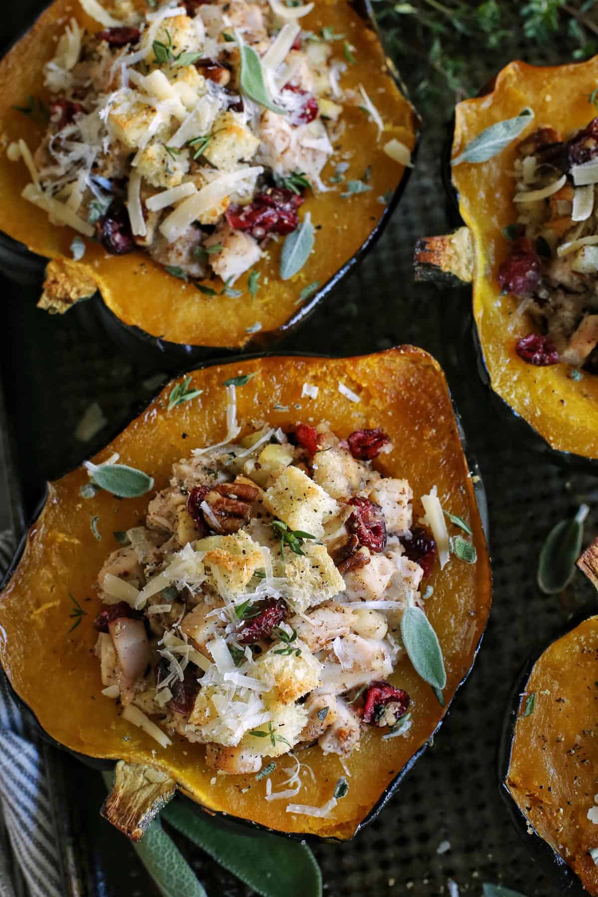 halves of acorn squash on pan, stuffed with a turkey and dressing mixture