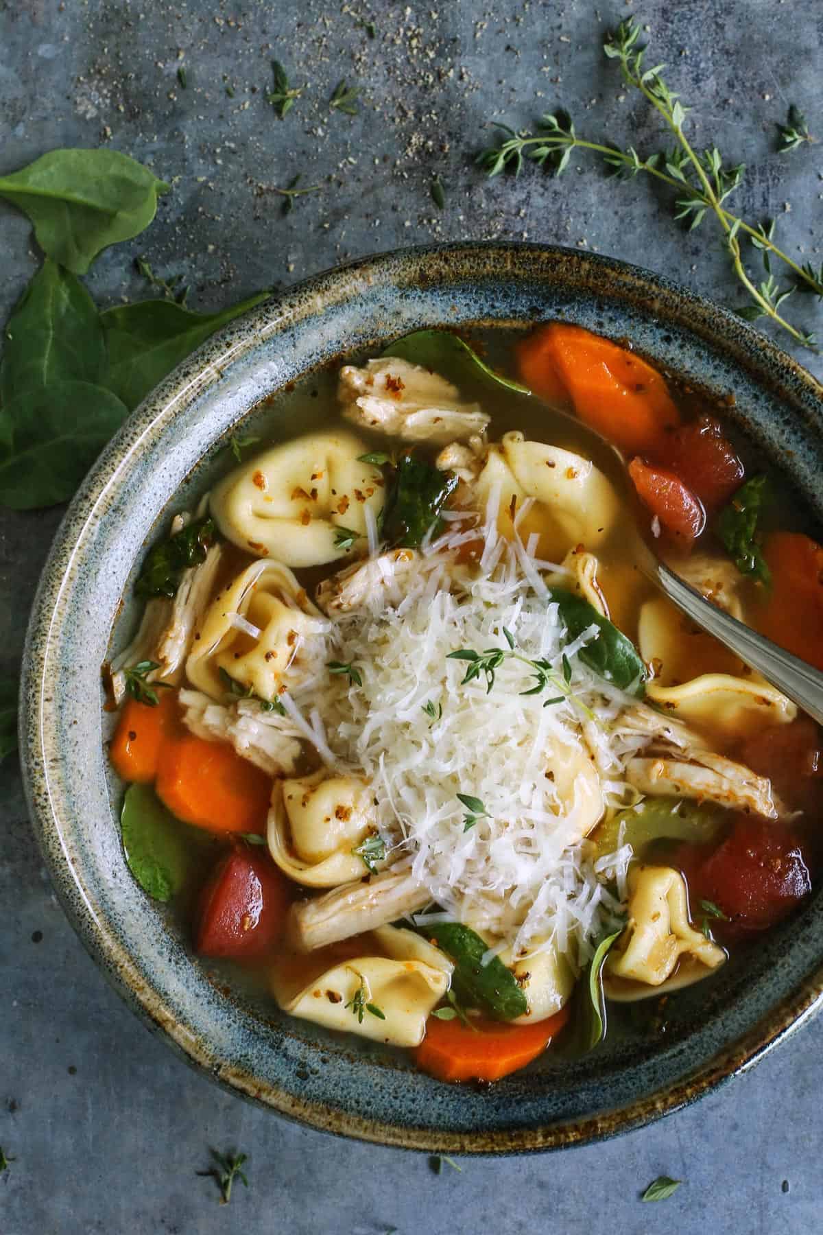 bowl of tortellini soup with turkey and vegetables