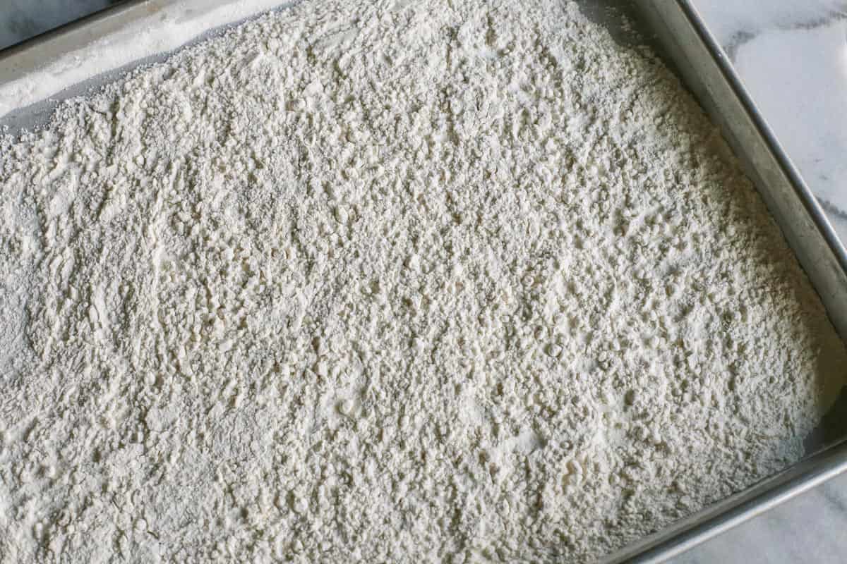 flour spread out on a large rimmed pan