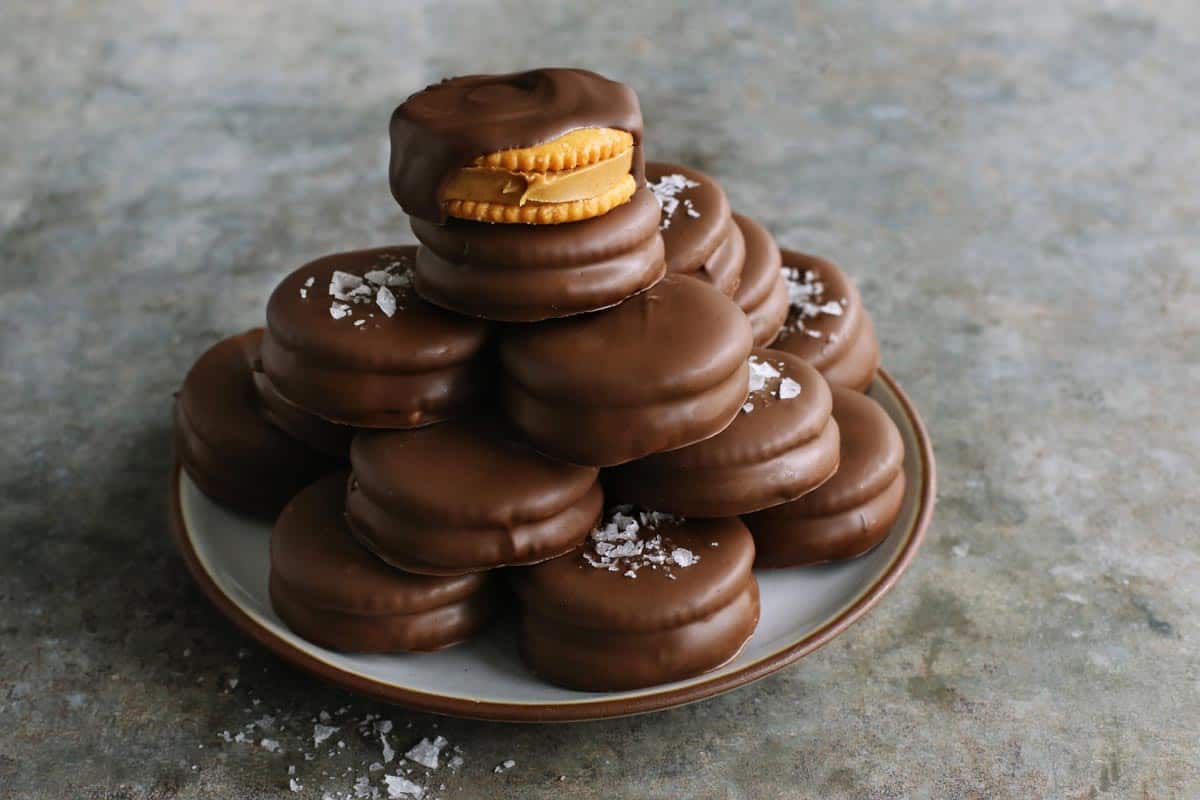 chocolate-dipped peanut butter Ritz cookies stacked on a plate