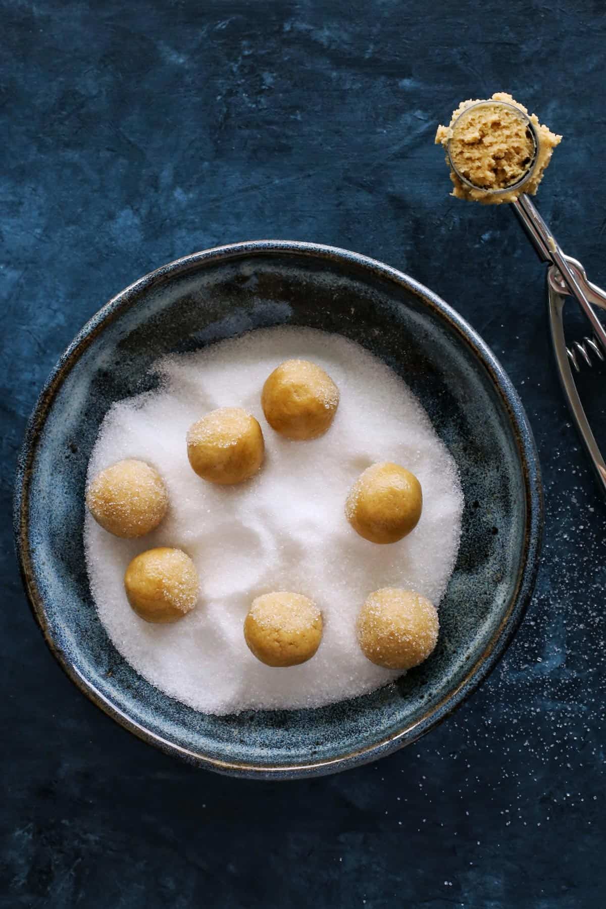 peanut butter dough rolled into balls and rolled in sugar