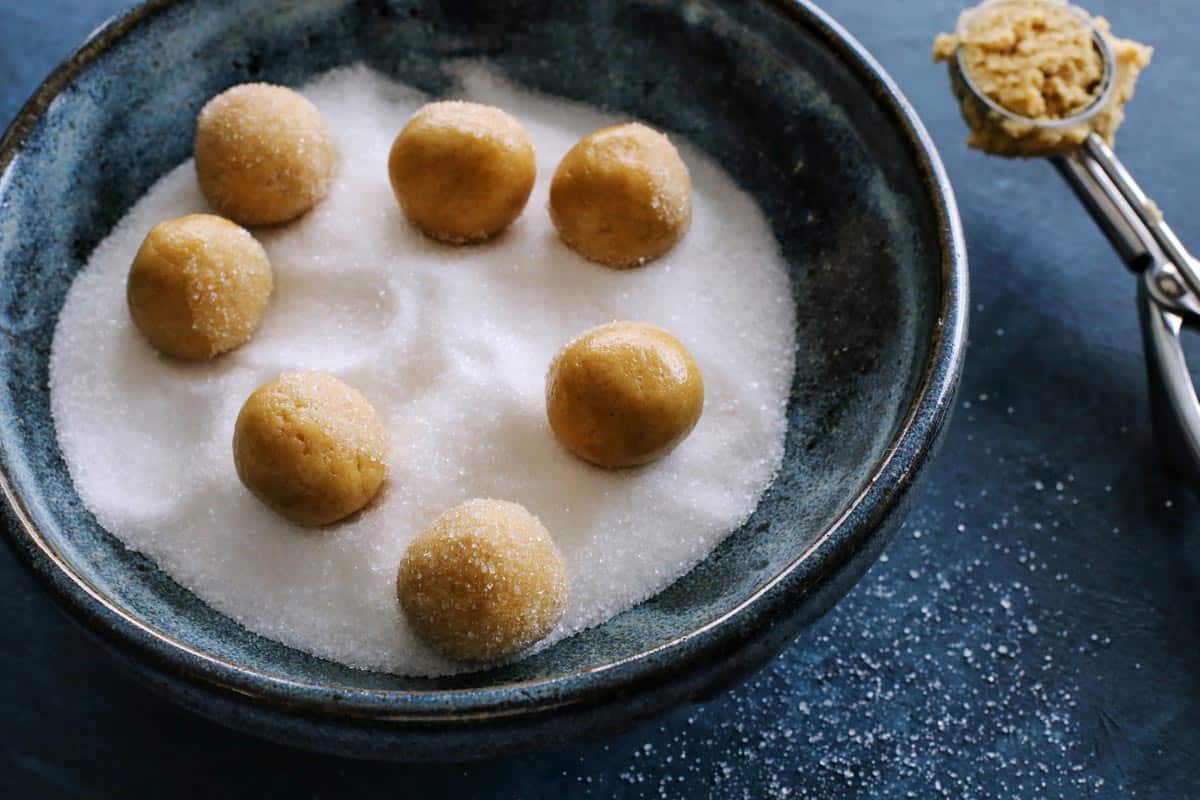 peanut butter cookie dough rolled into balls and rolled in sugar