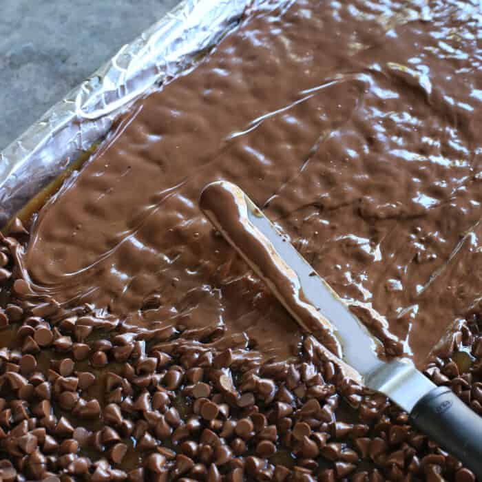 A spatula spreading melted chocolate chips