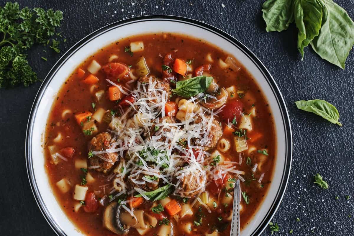 meatball ditalini soup in a bowl with cheese 