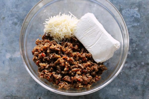 browned Italian sausage, cream cheese, and shredded Parmesan cheese in a bowl