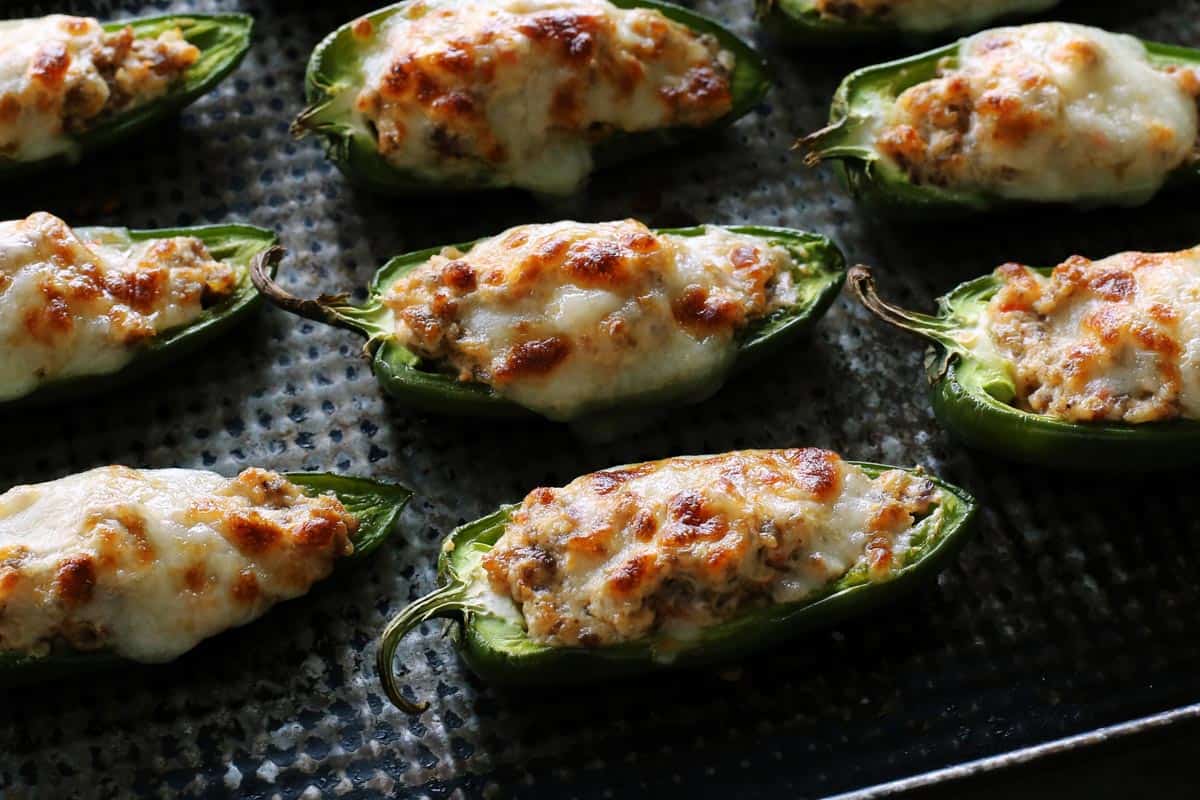 baked stuffed jalapeno peppers baked on a pan