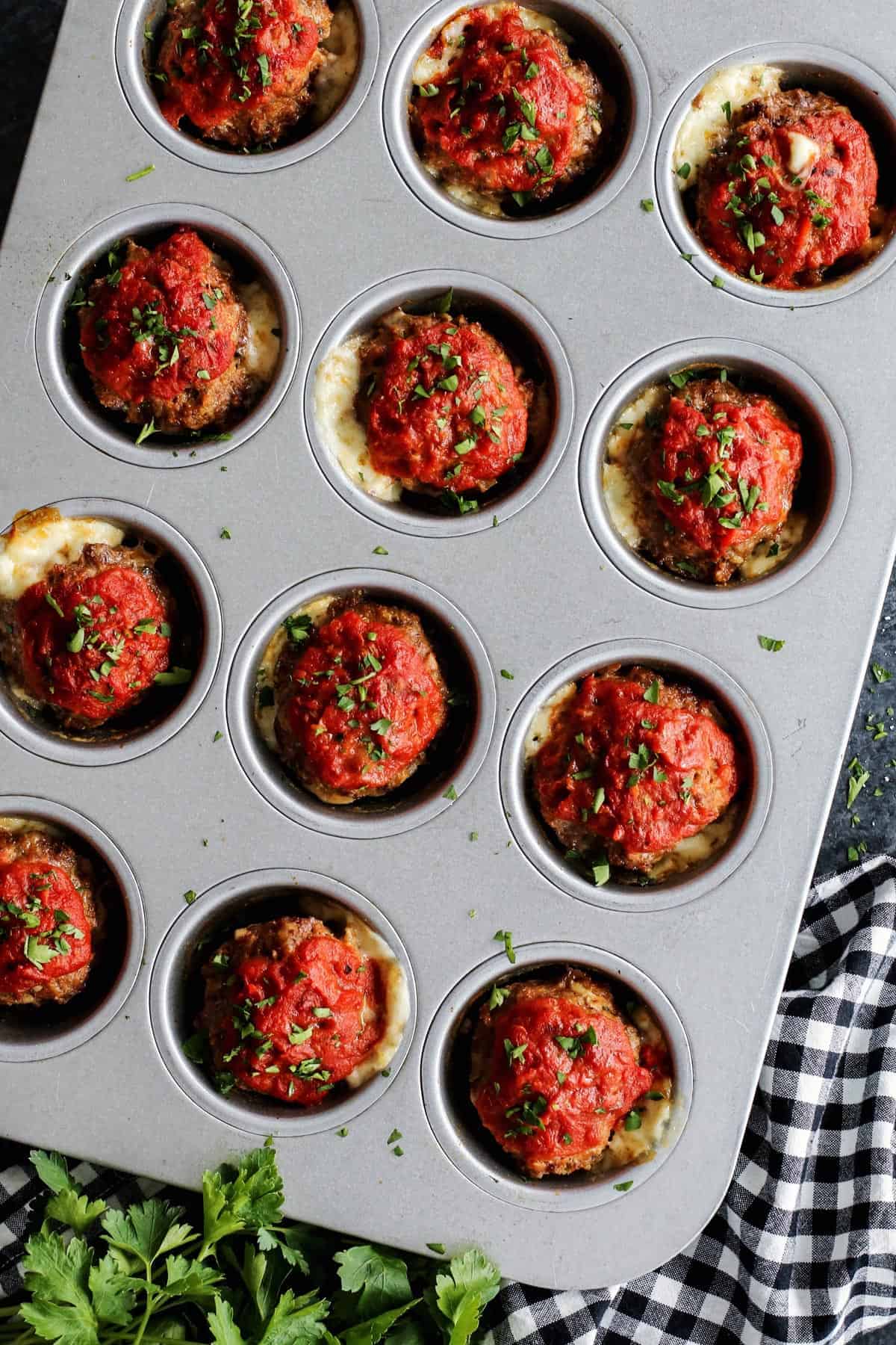 Meatloaf muffins with cheese in a muffin pan