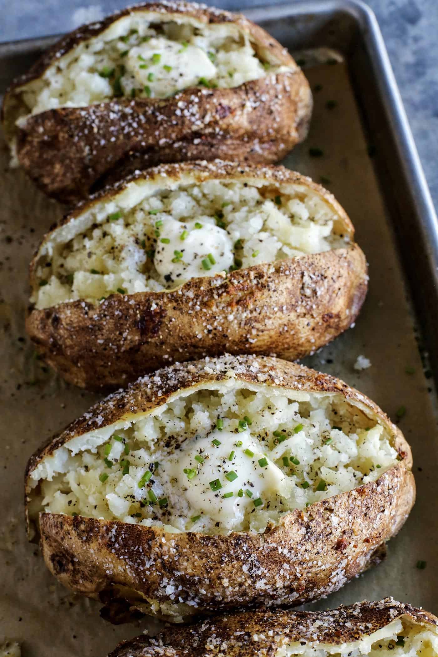 potatoes baked in the oven, split open, with butter and chives