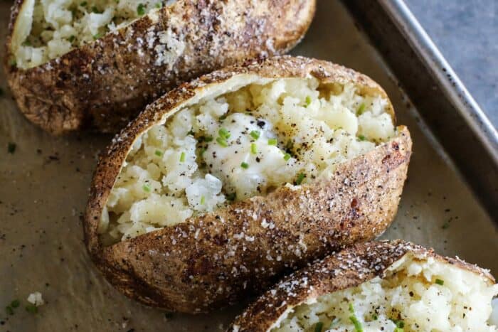 butter and chives on baked potatoes