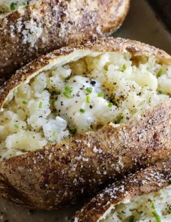 baked potato cut open, with crispy skin and tender insides