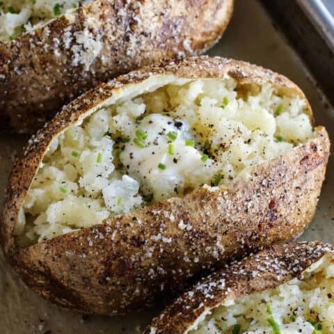 baked potato cut open, with crispy skin and tender insides