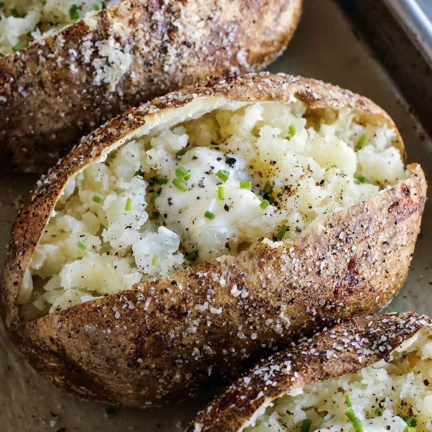 baked potato cut open, with crispy skin and tender insides