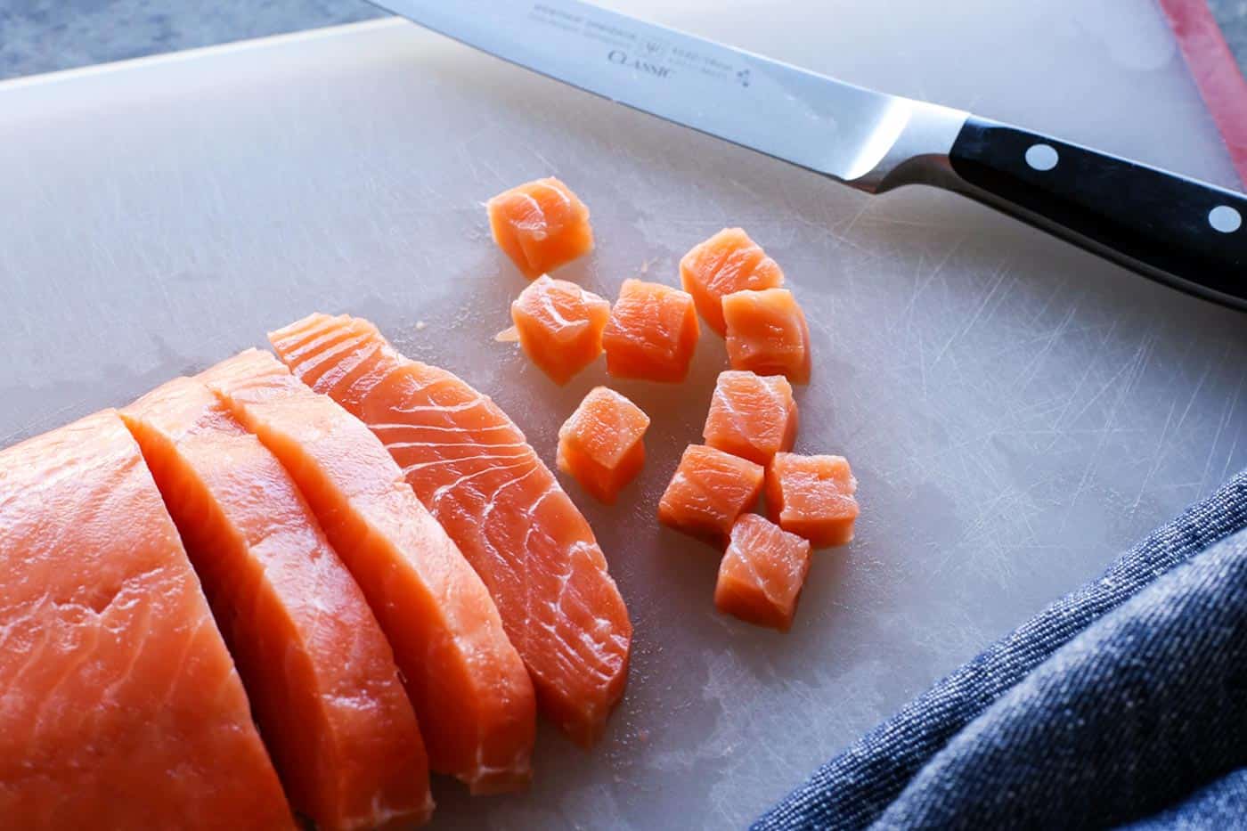 raw sushi grade fish on a cutting board