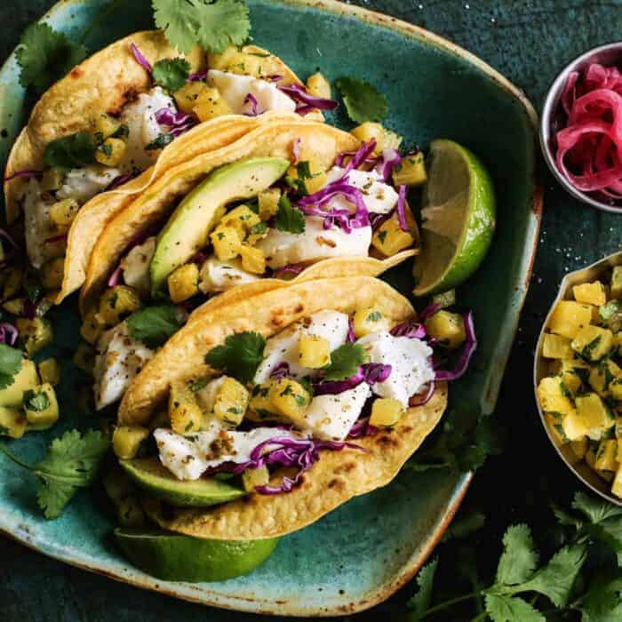 fish tacos with roasted pineapple on a plate