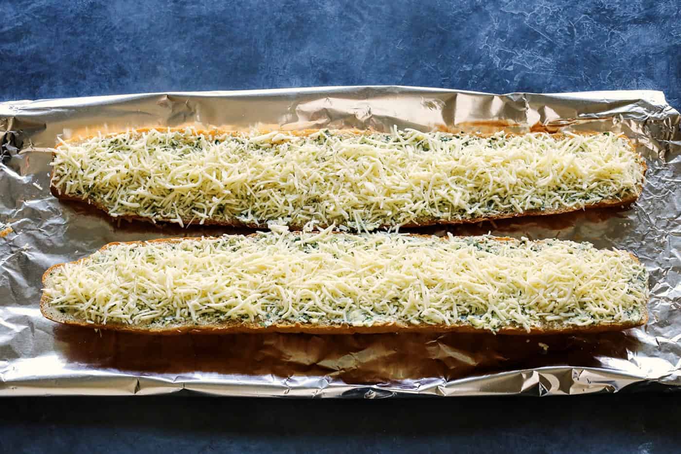 shredded cheese on garlic bread halves