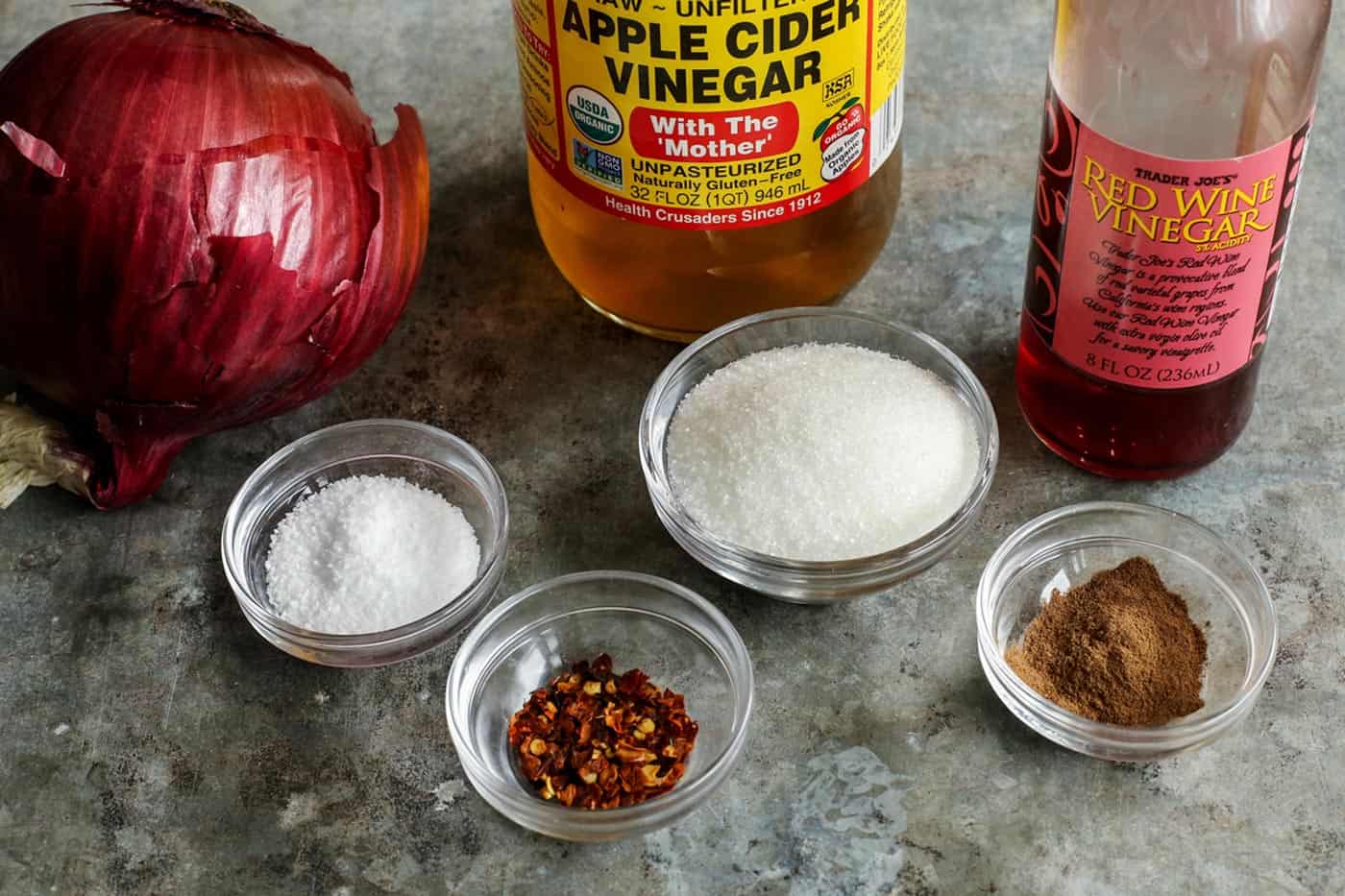 ingredients for pickled red onions - red onion, apple cider vinegar, red wine vinegar, salt, sugar, chili flakes, allspice