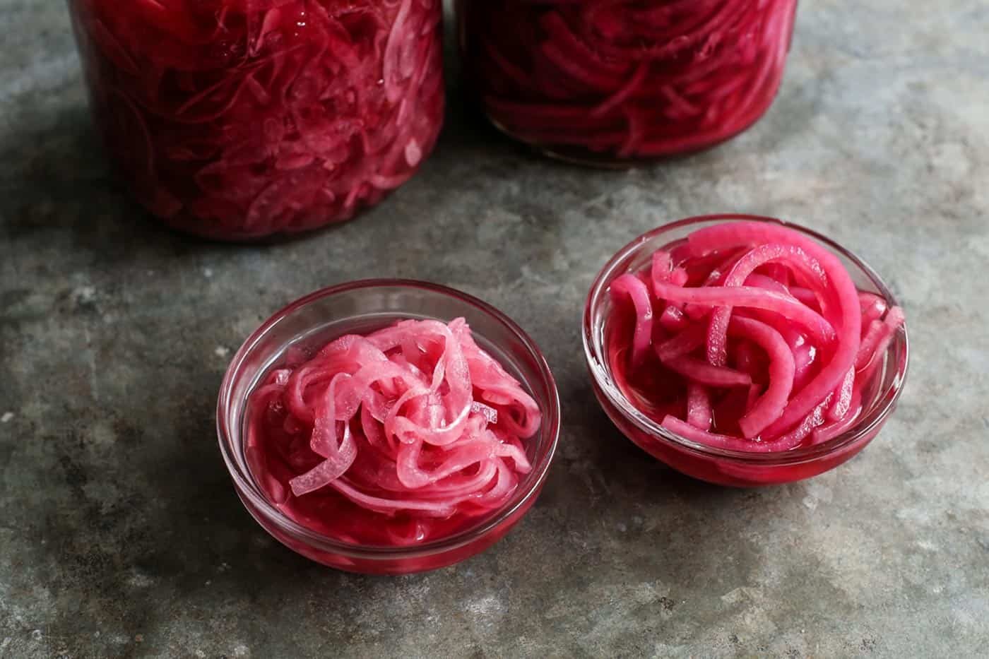 Small bowls filled with pickled red onions