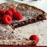Pinterest image of Swedish Kladdkaka chocolate cake on white cake plate