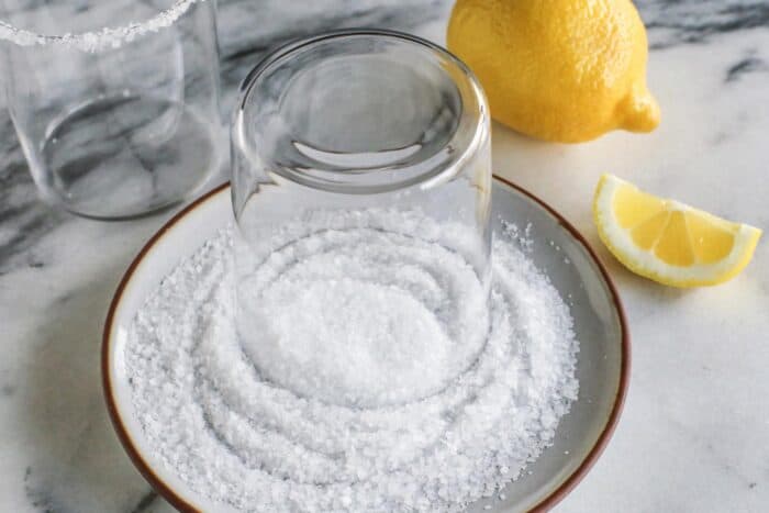 rimming a glass with fresh lemon juice and coarse salt