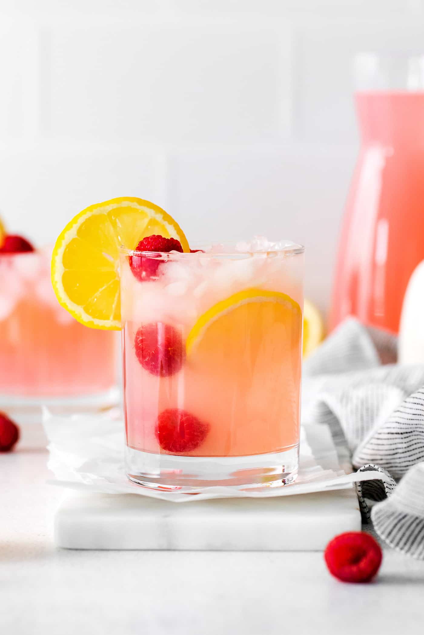 A pink lemonade margarita in a short glass