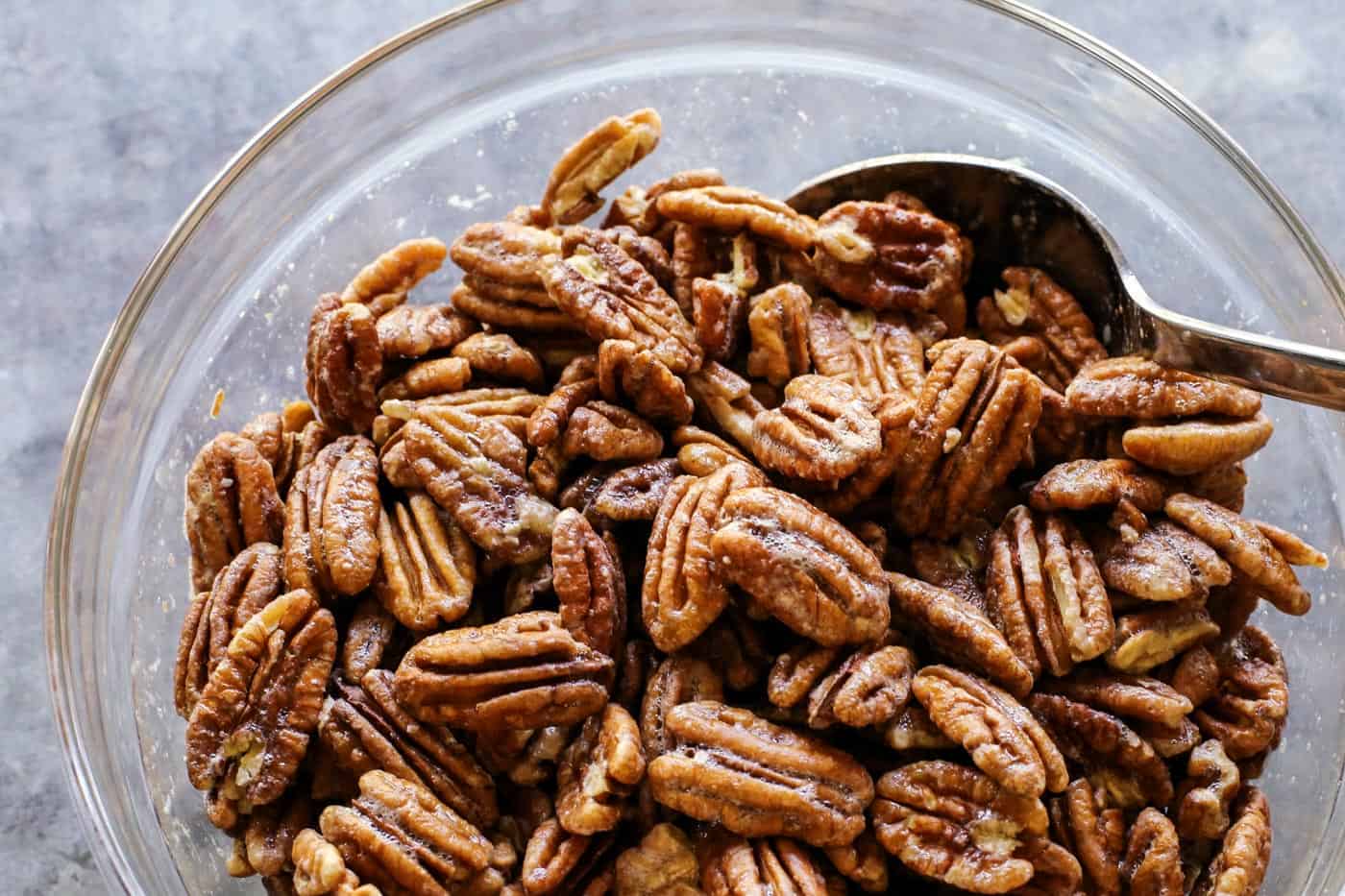 a bowl of pecans coated in whipped egg white