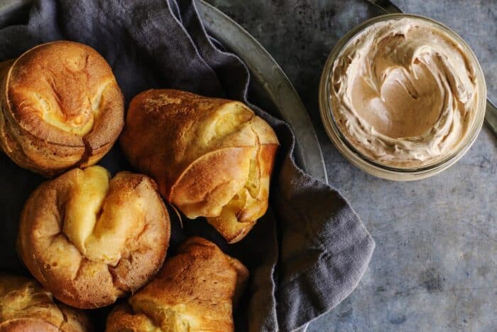 popovers made with sourdough starter, plus a jar of cinnamon honey butter