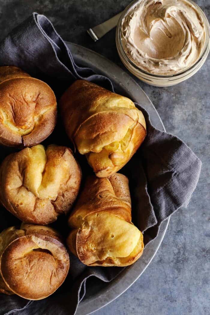 basket of popovers and a jar of cinnamon honey butter
