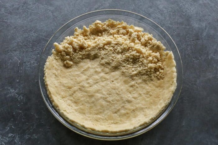 pressing dough into pie plate