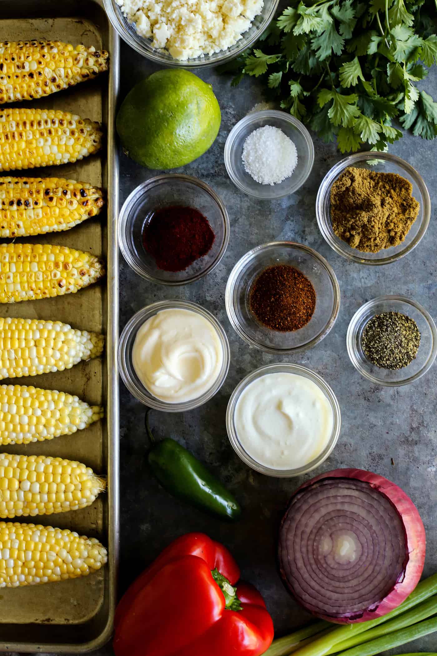 ingredients to make Mexican corn salad, all in separate containers