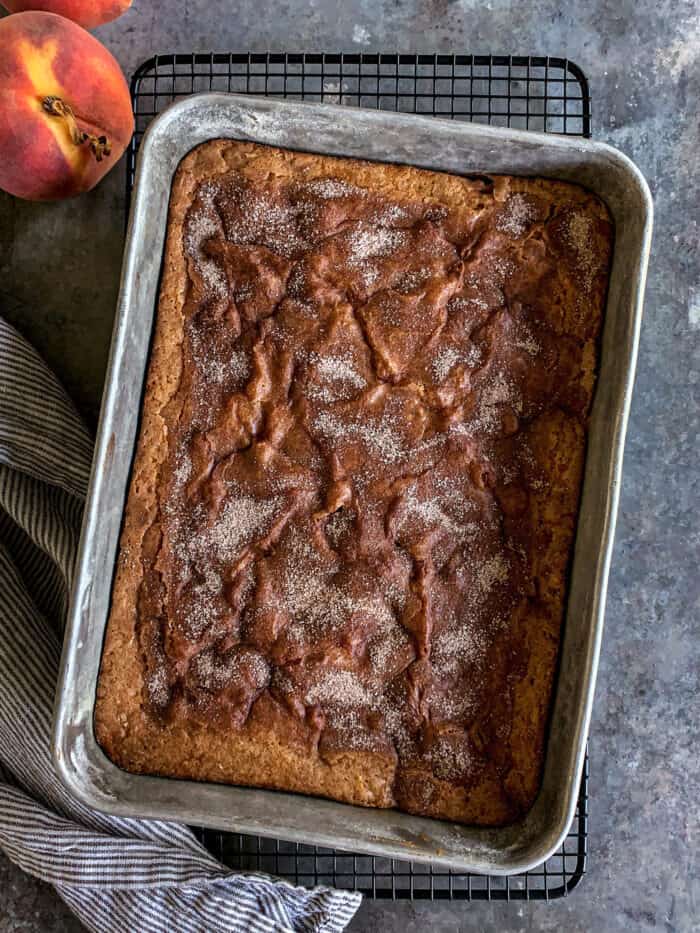 baked peach cake in a metal 9" x 13" pan