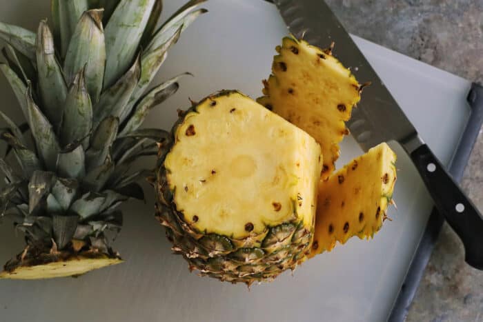 whole pineapple with top and some of the skin cut off