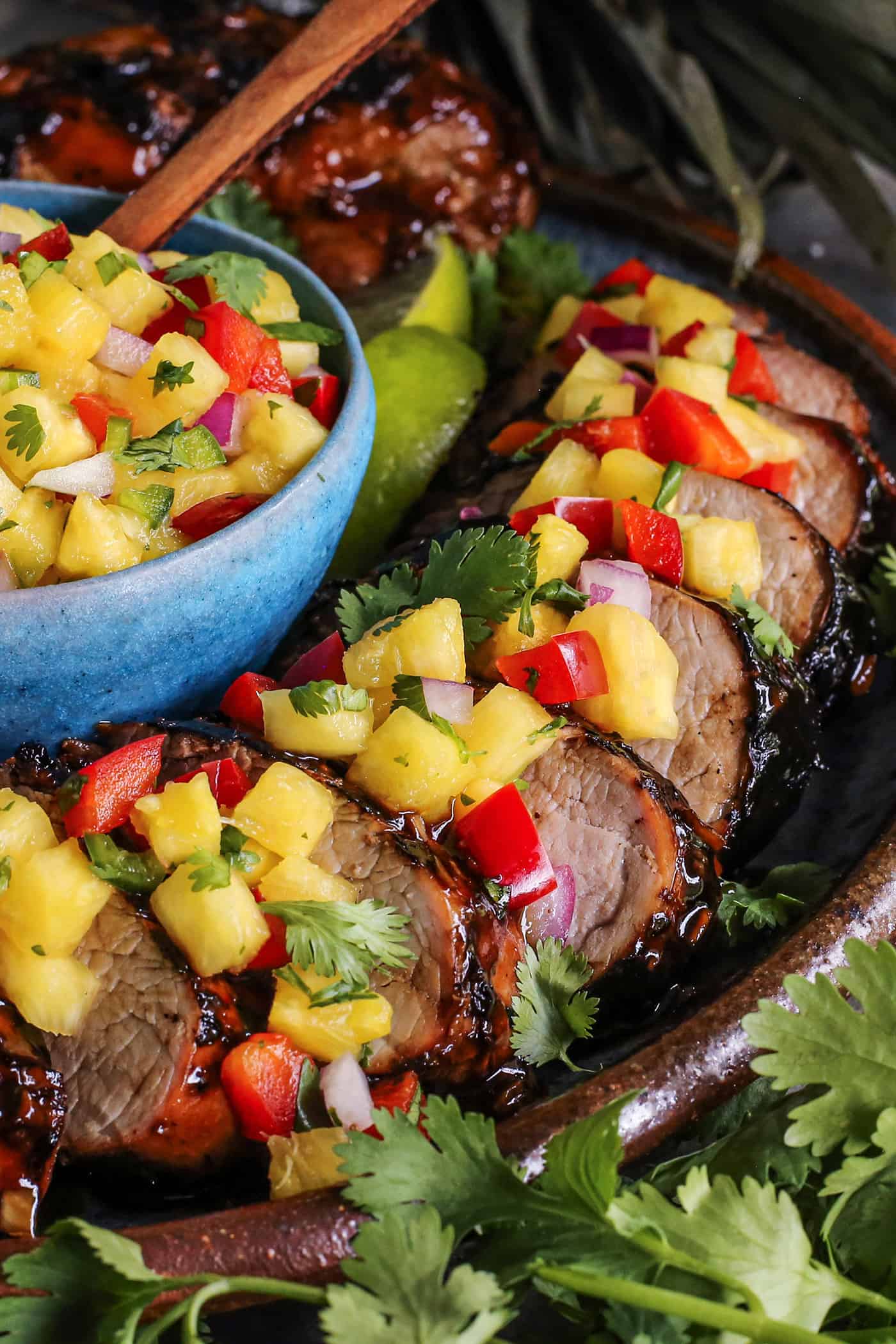 Teriyaki Pork Tenderloin bathes tender pork in a homemade marinade, grills it to perfection, and tops it with juicy fresh pineapple salsa. sliced pork tenderloin with fresh pineapple salsa