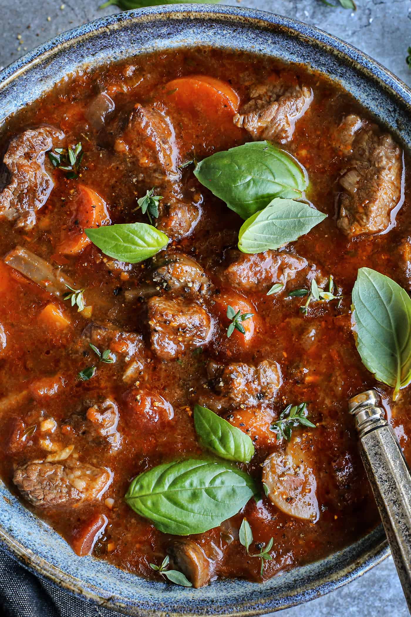 overhead close-up photo of Italian stew in a blue pottery bowl