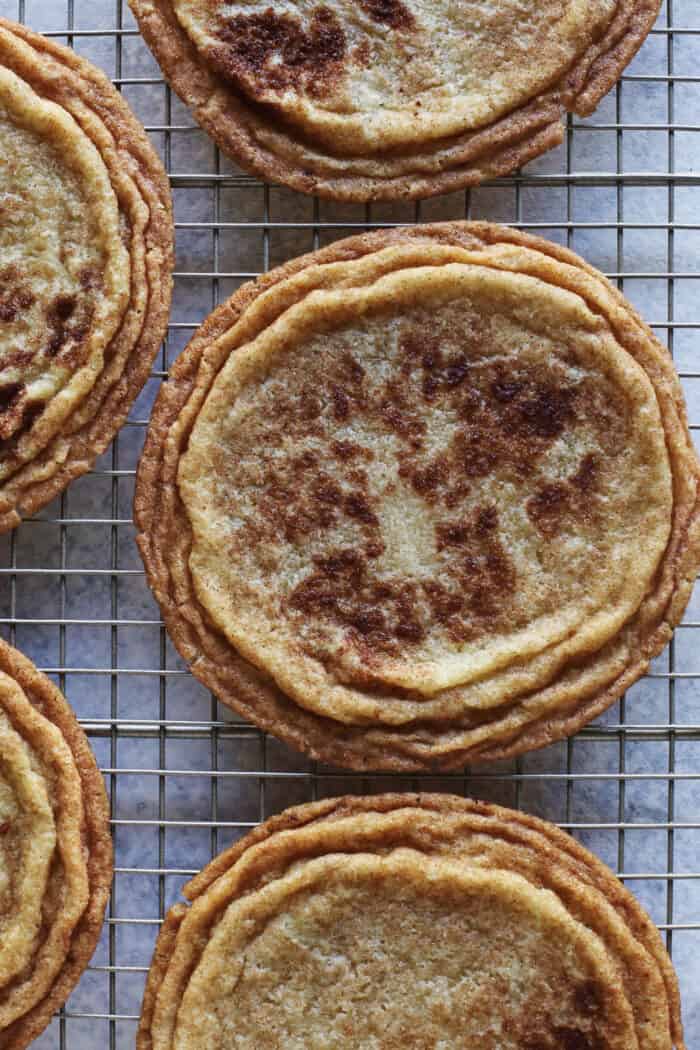 several giant snickerdoodle cookies on a cooling rack