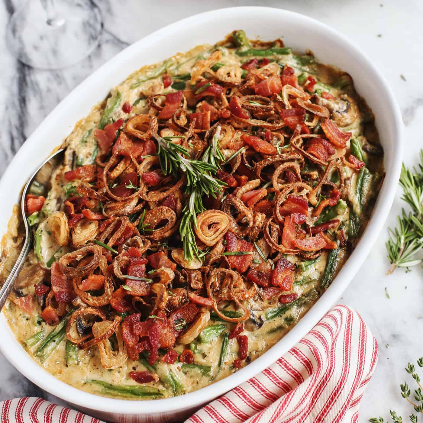 A large dish of bacon and shallot-topped green bean casserole.