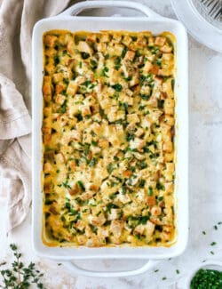 Leftover turkey casserole straight out of the oven, garnished with fresh thyme and crunchy chives.