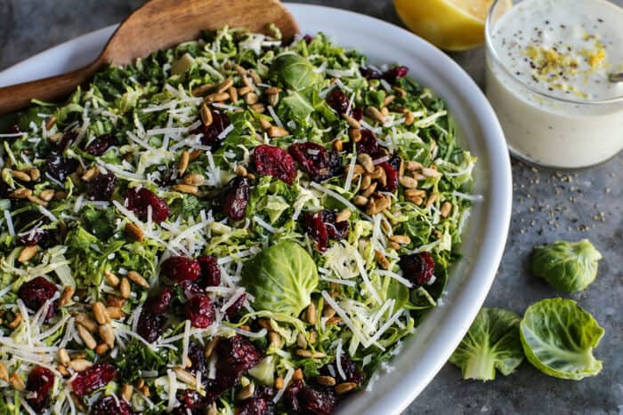 white platter with Brussels sprouts and kale salad, plus lemon yogurt dressing