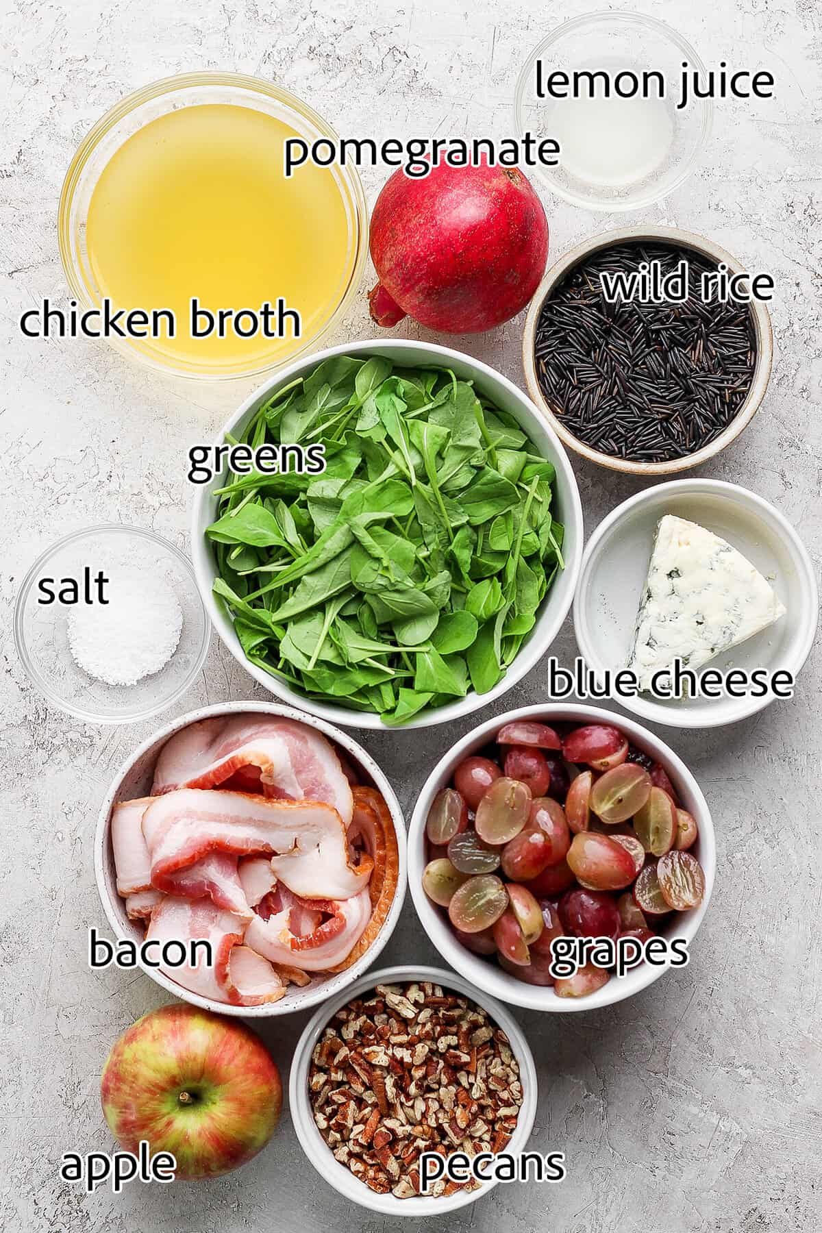 Labeled ingredients for making holiday wild rice salad. 