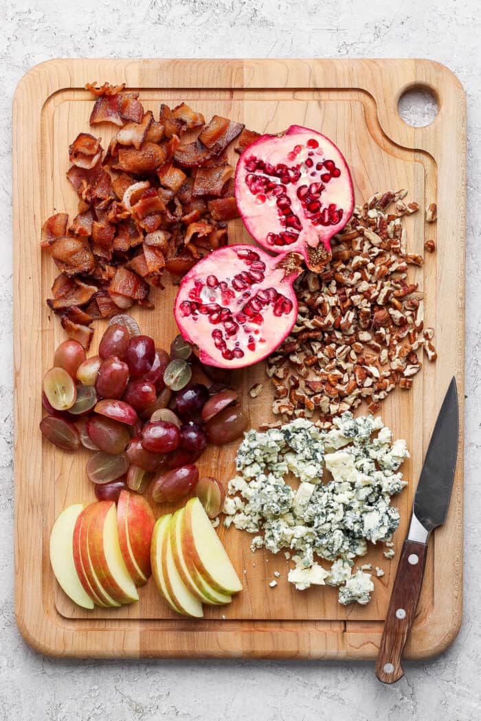 Ingredients for making wild rice salad on a cutting board.