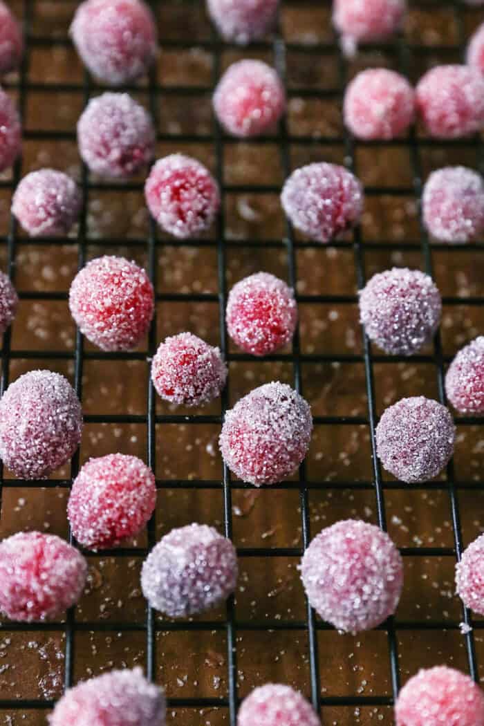 sugared cranberries drying on a cooling rack