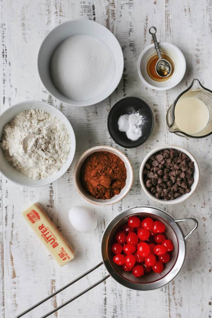 ingredients for chocolate cherry cookies laid out on a white table