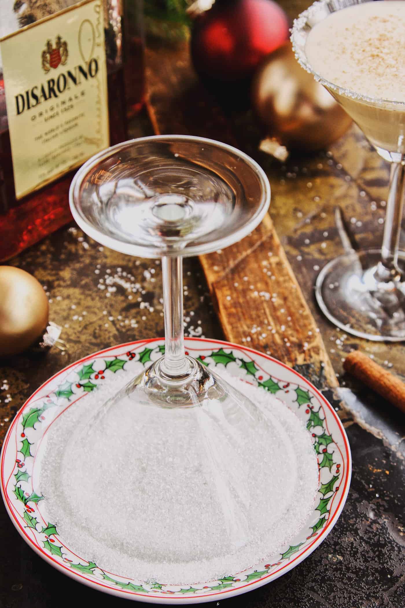 a martini glass overturned in a small plate of sugar