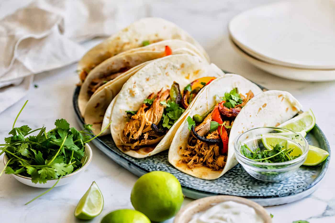 a platter of tacos with carnitas meat and sauteed sweet peppers