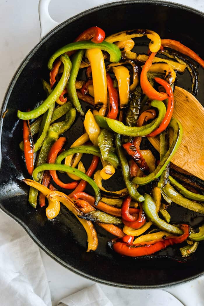 sauteed sweet bell peppers in a white skillet