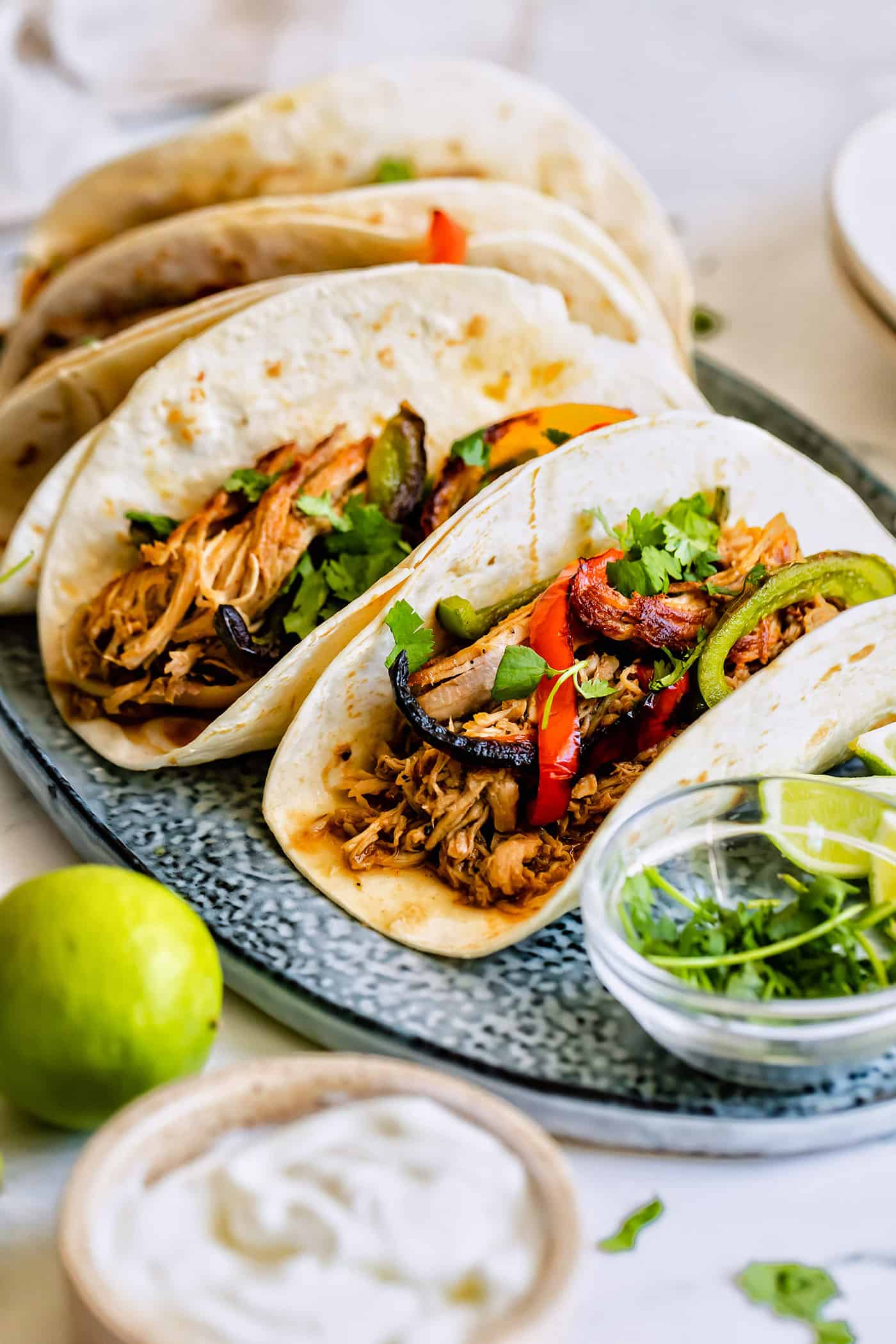 a platter of carnitas tacos with sauteed sweet peppers