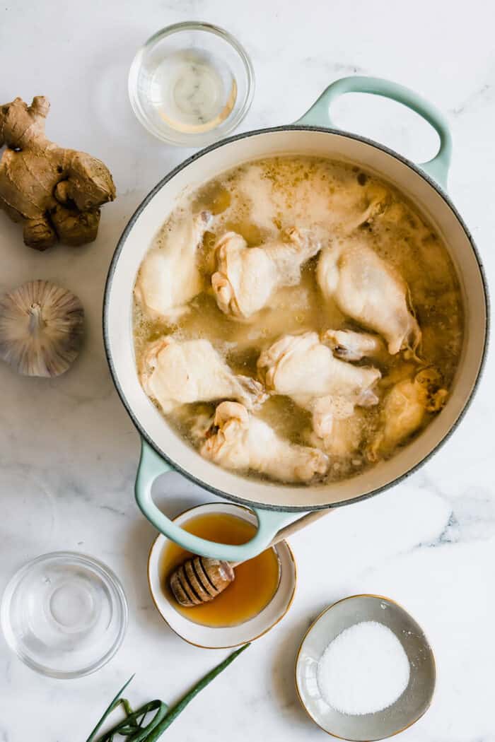 parboiled chicken wings in a large pot