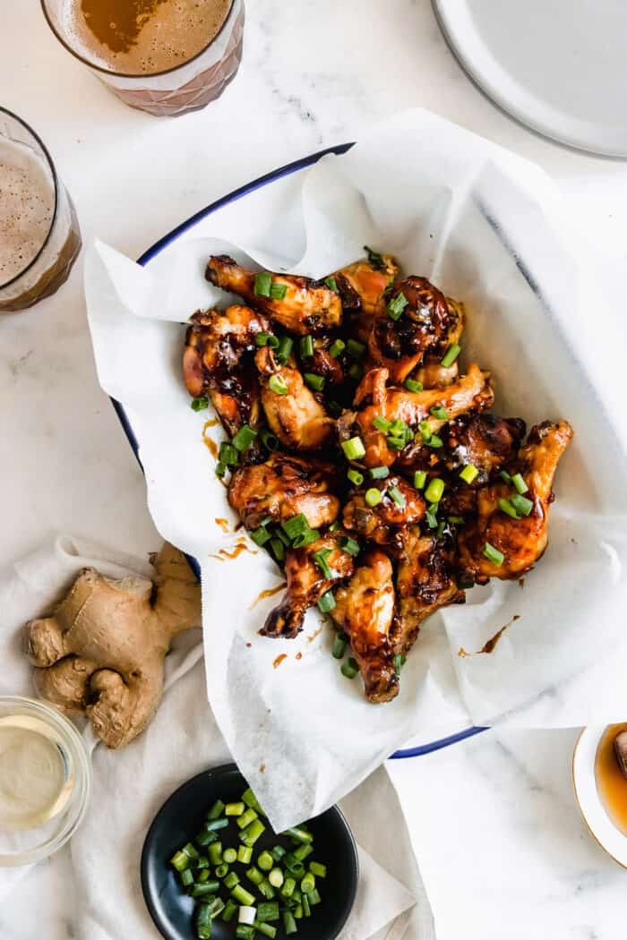 overhead photo of oyster sauce chicken wings in a parchment paper lined tray