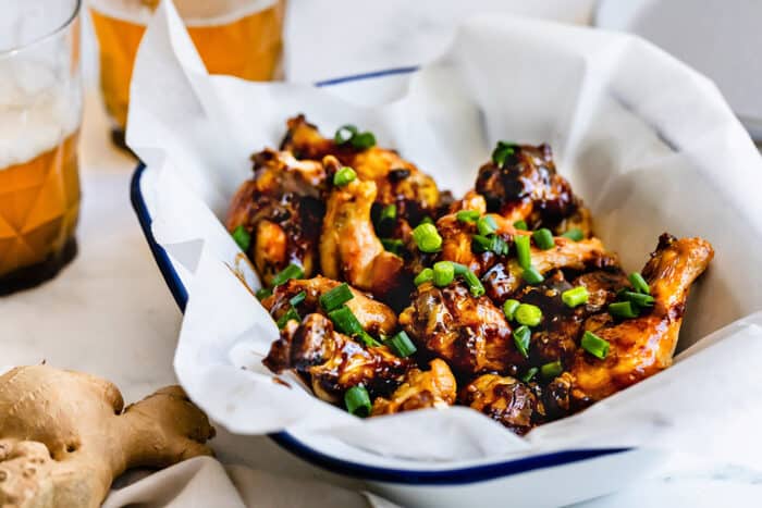 a tray of chicken wings with oyster, plus a couple glasses of beer