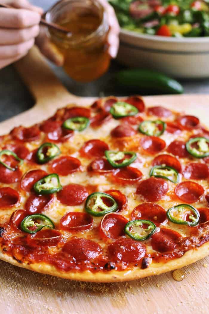 thin crust pizza with honey, pepperoni, and jalapeno